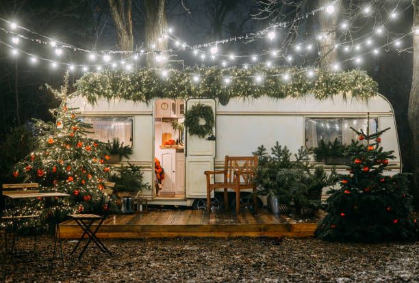 a mobile home is decorated for christmas with lights strung over the front door and deck