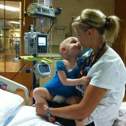 a woman holding a baby in a hospital room