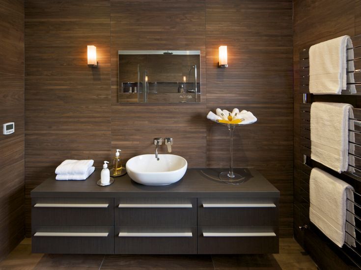 a bathroom with two sinks and towels hanging on the wall