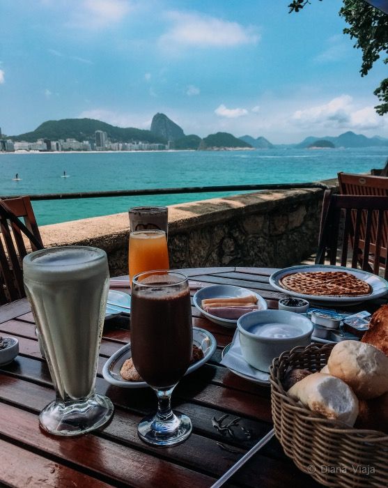 an outdoor table with food and drinks on it