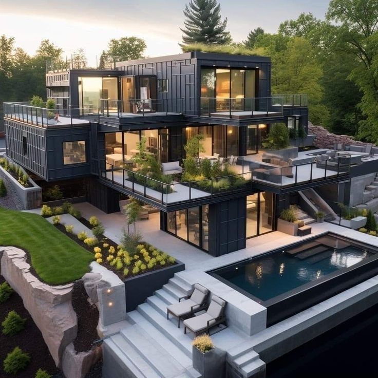 an aerial view of a modern house with pool and landscaping in the foreground, surrounded by trees