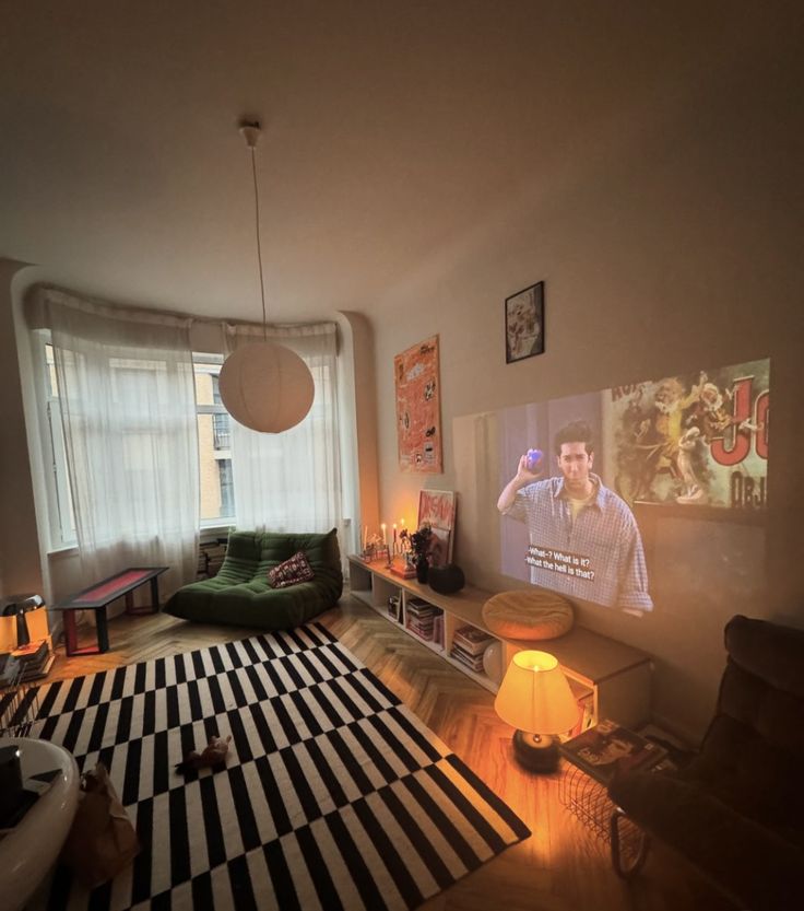 a living room filled with furniture and a flat screen tv mounted to the side of a wall