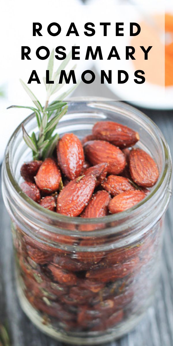 roasted rosemary almonds in a glass jar on a wooden table with text overlay