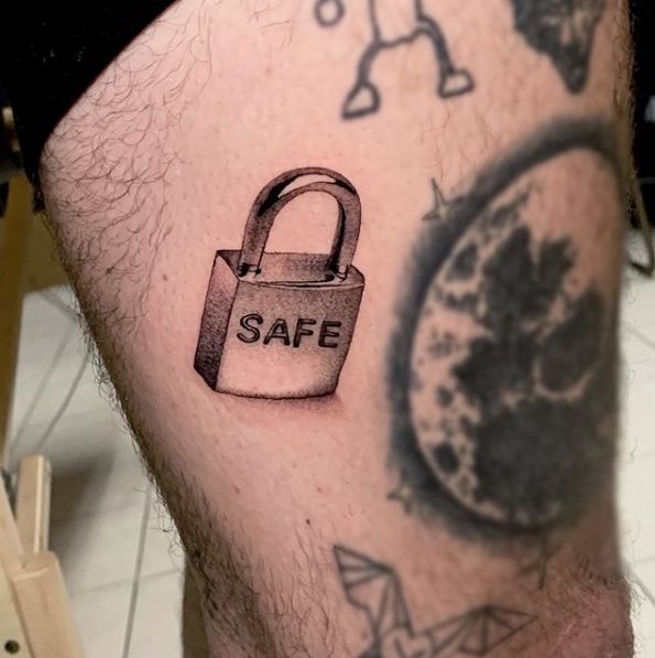 a man's leg with a lock on it and the word safe written on it