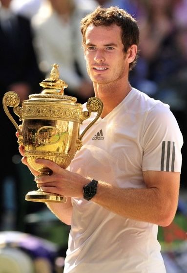 a male tennis player holding up a trophy