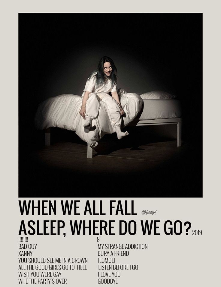 a woman sitting on top of a white bed in the middle of a dark room