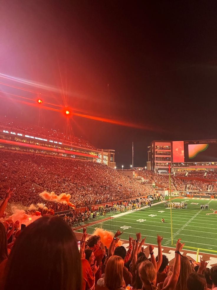 a football stadium filled with fans and lights