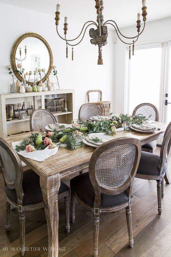 the dining room table is set with plates and place settings