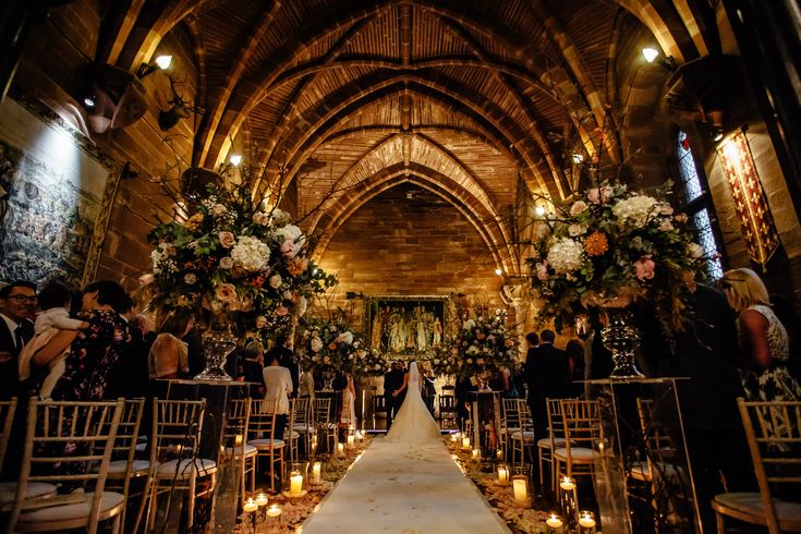 a bride and groom walking down the aisle at their wedding ceremony in an old church