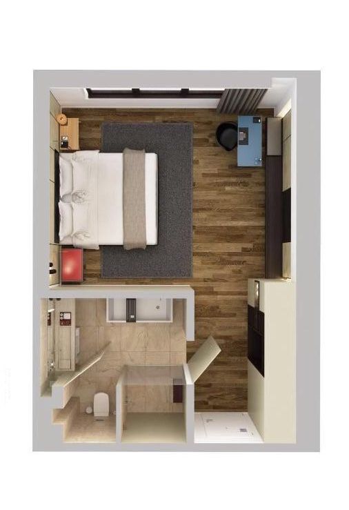 an overhead view of a bedroom and living room in a small apartment with wood flooring