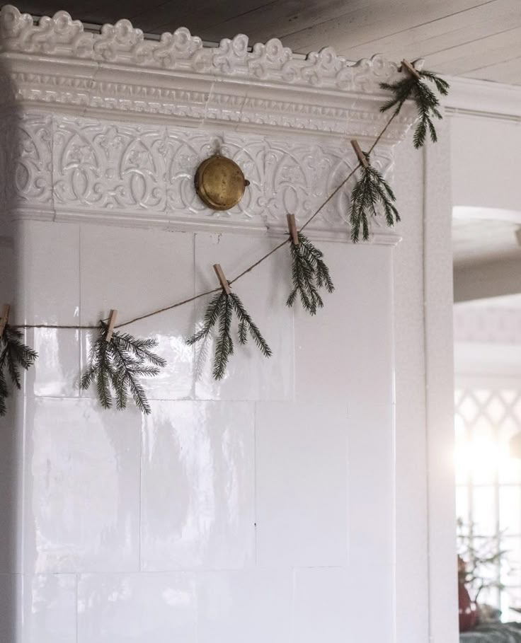 some pine branches are hanging on the wall