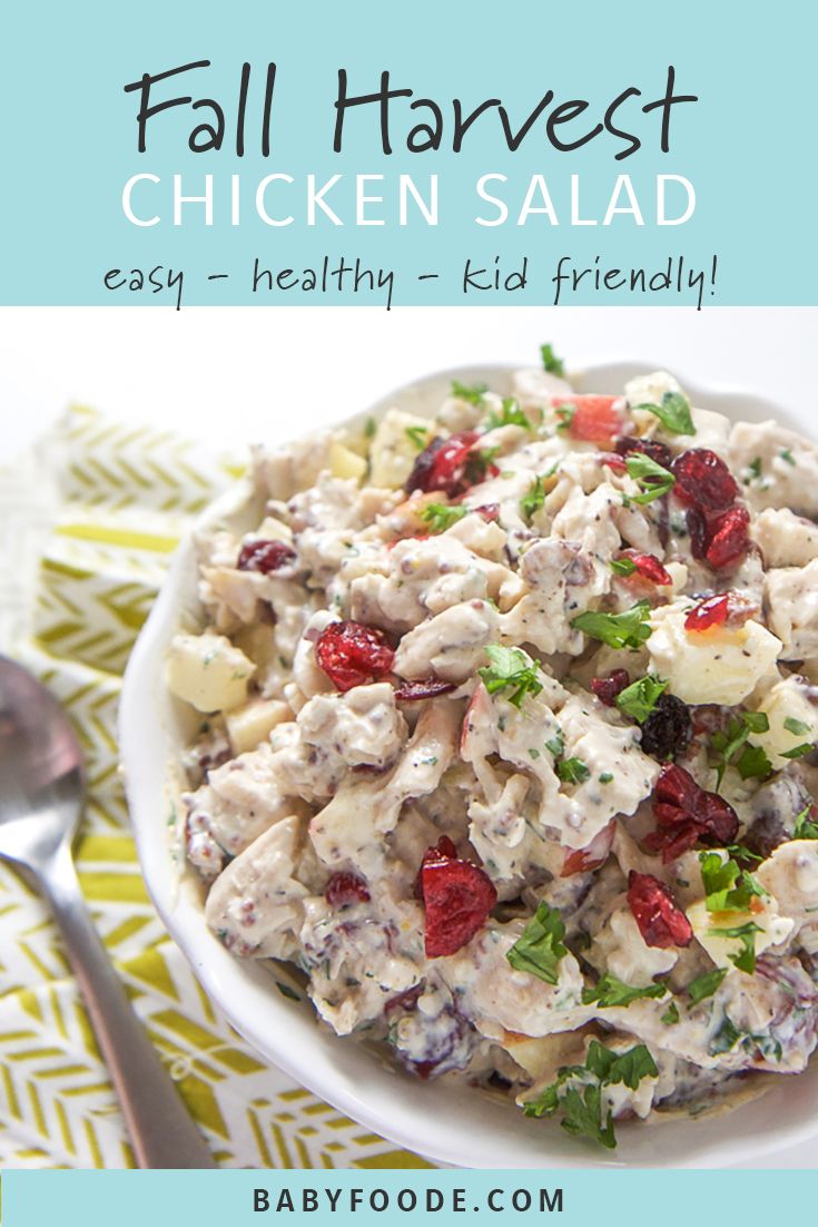 a white bowl filled with chicken salad on top of a table