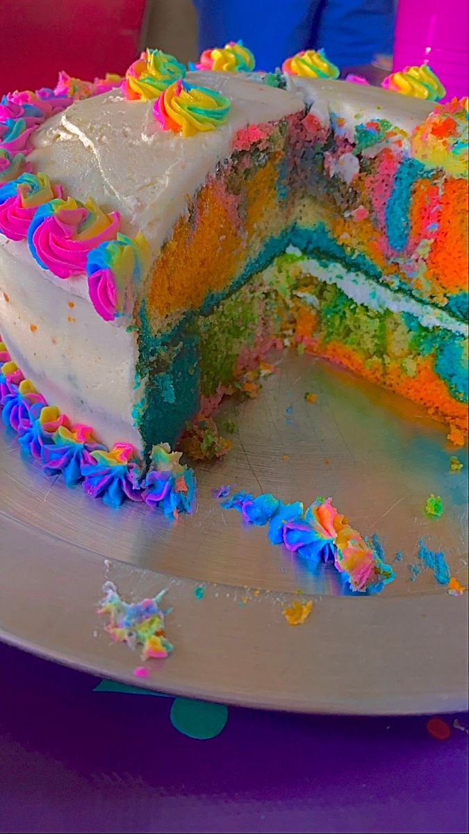 a cake that has been cut in half on a plate with sprinkles