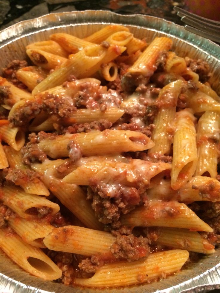 a metal pan filled with pasta and meat