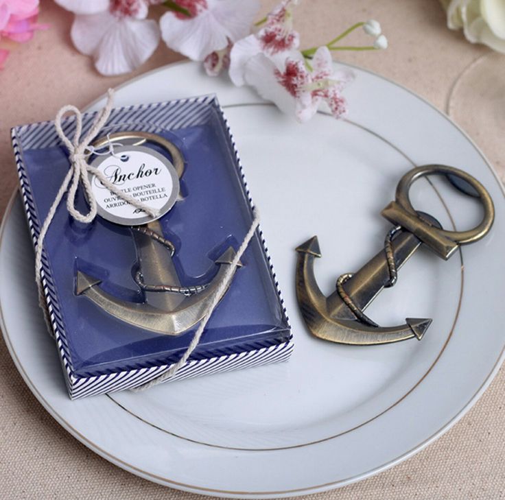 an anchor and key on a plate next to a package with a tag that says, i love you