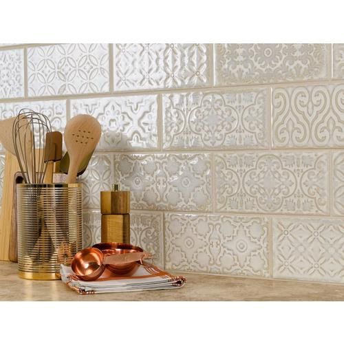 kitchen utensils and cooking utensils in gold containers on a counter top