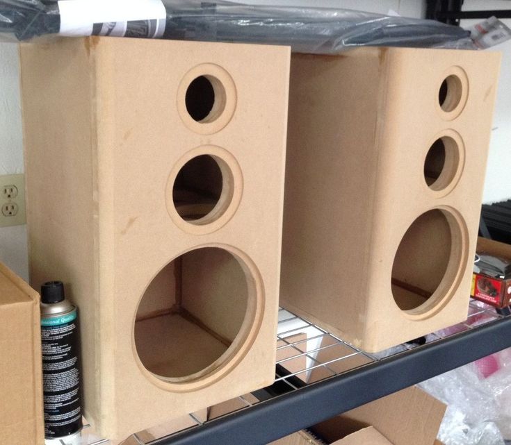 two cardboard speakers sitting on top of a shelf