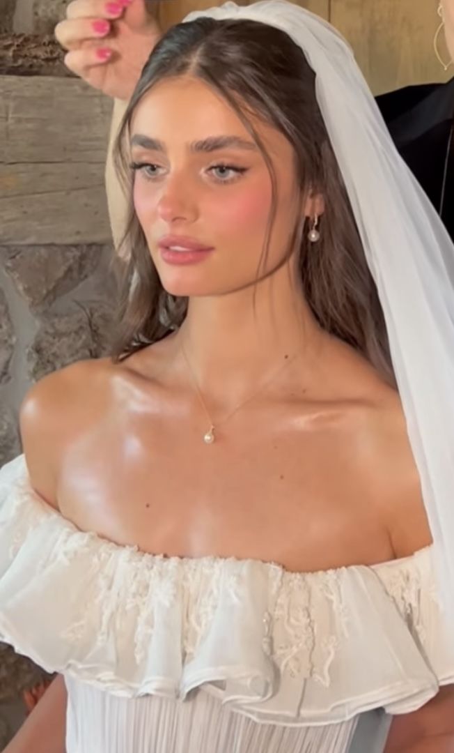 a woman in a white wedding dress and veil