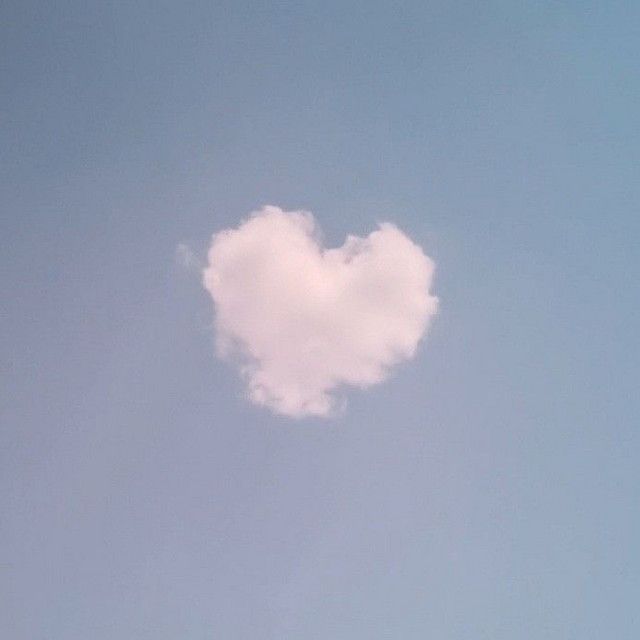 a heart shaped cloud floating in the sky