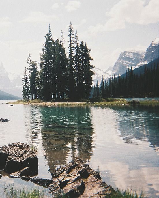 a lake surrounded by mountains and trees