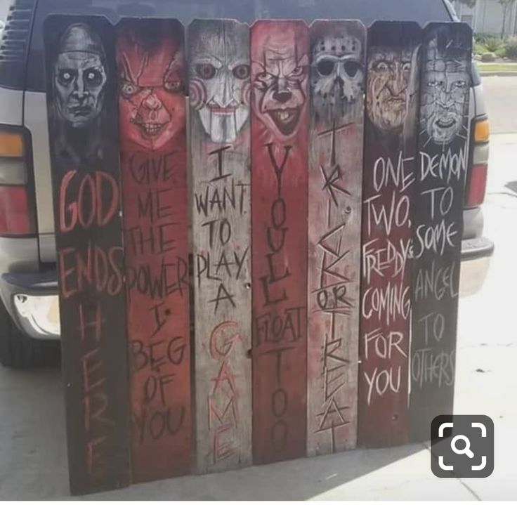 a car parked next to a row of wooden signs with words written on them in different languages