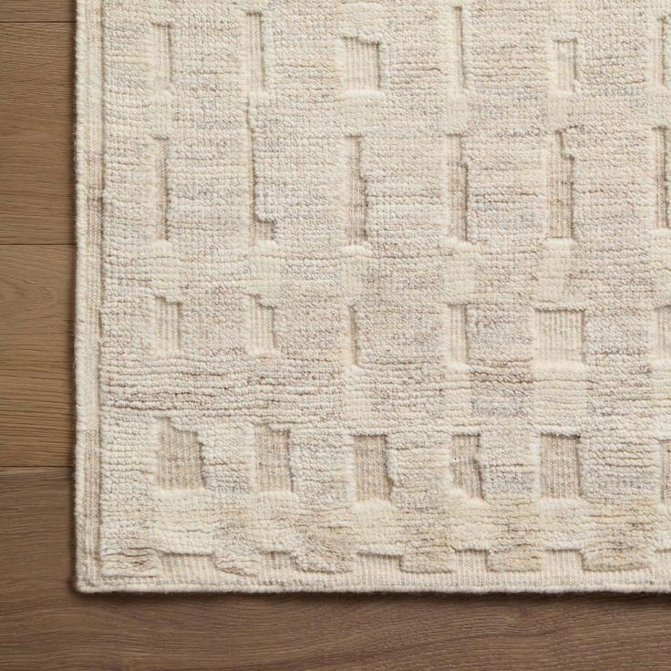 a white rug on top of a wooden floor