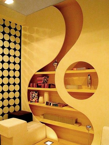 a living room filled with furniture next to a wall covered in circles on the walls