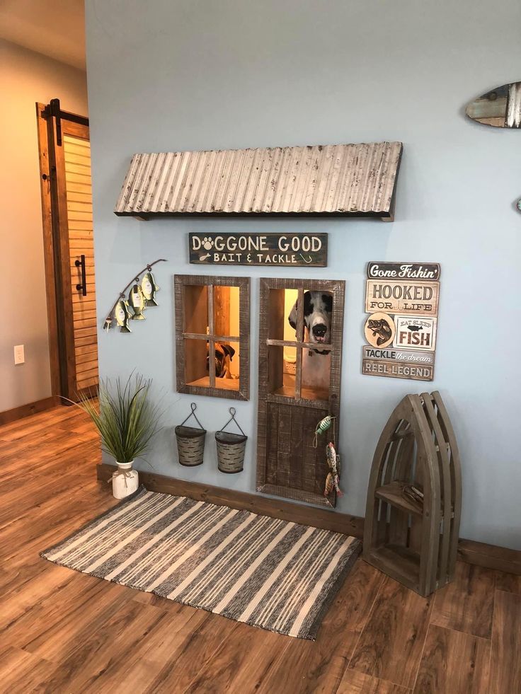 a dog kennel is shown with its doors open and some decorations on the wall