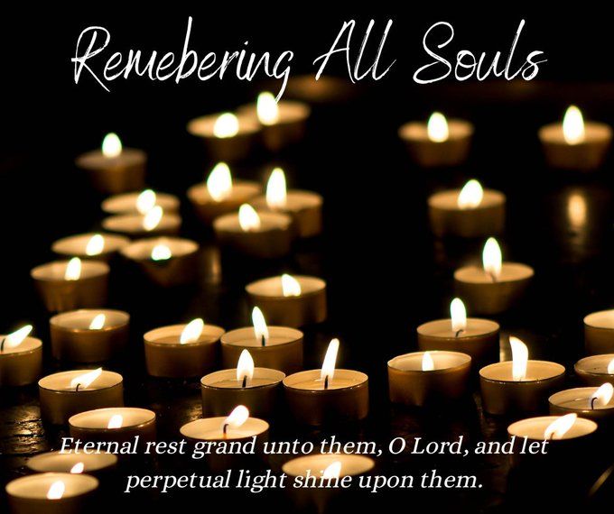 many lit candles with the words, remebering all souls