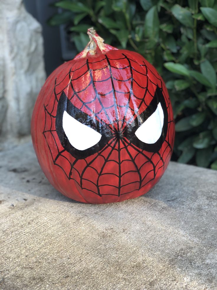 a spiderman pumpkin with eyes painted on it