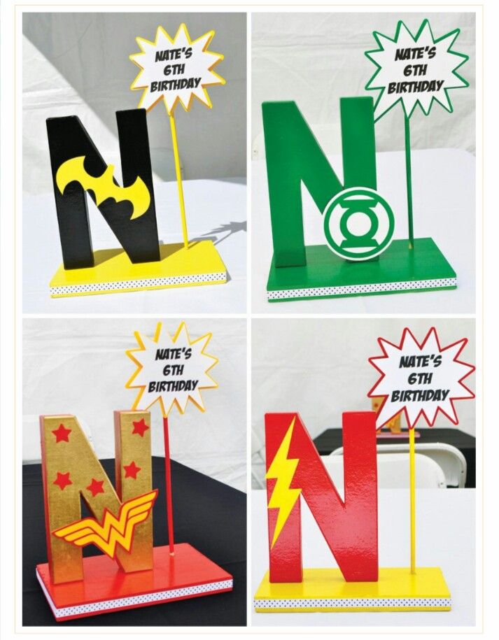 four different types of letters and numbers made out of construction paper, each letter has a superhero symbol on it