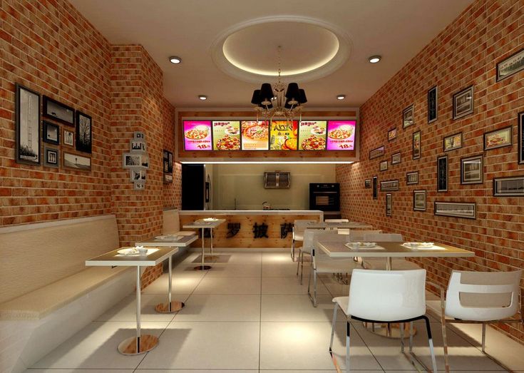 the interior of a restaurant with tables, chairs and pictures on the wall above them