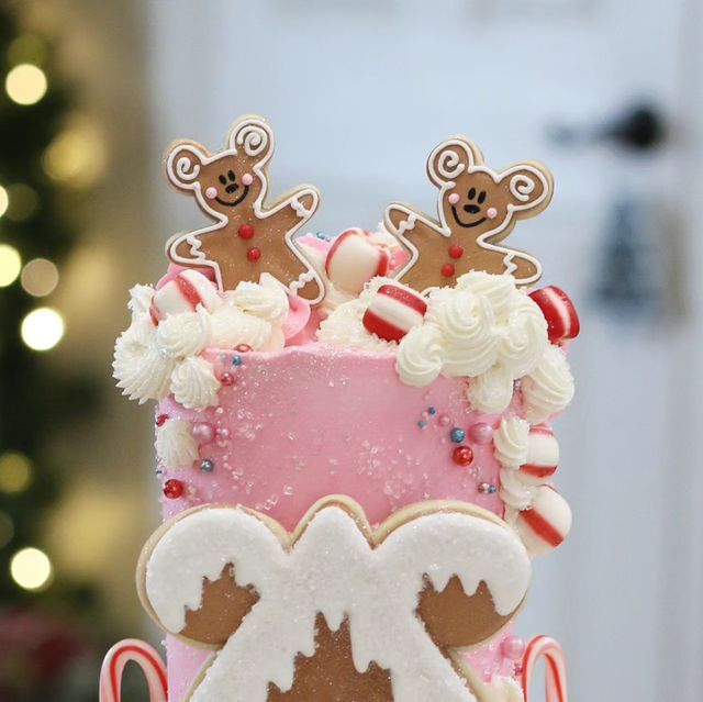 a three tiered cake decorated with gingerbreads and candy canes