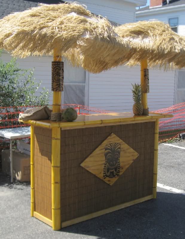 a tiki bar with straw umbrellas on top