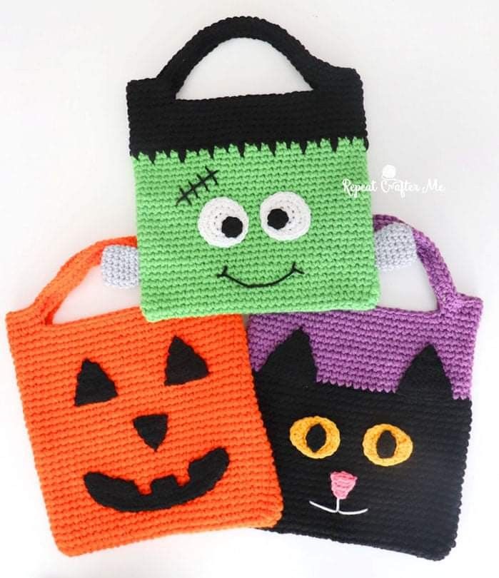 three crocheted halloween bags with faces on them