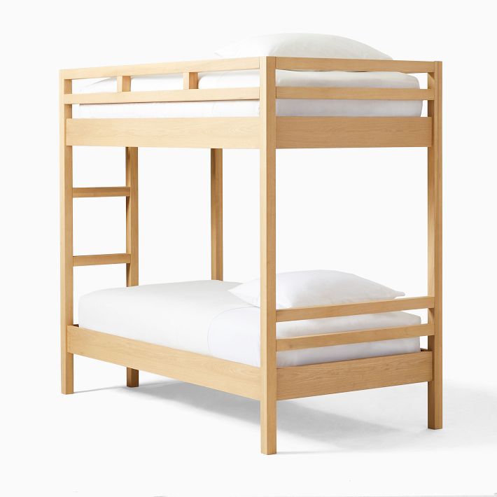 a wooden bunk bed with white sheets on it's bottom and bottom mattresses