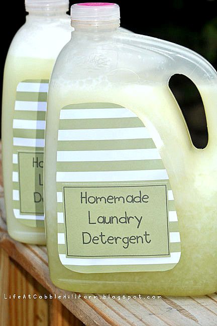 two gallon jugs of homemade laundry deterant sitting on a wooden table