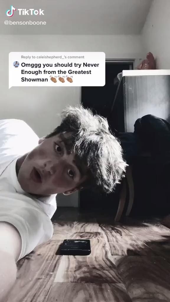 a man laying on the floor in front of a tv with an awkward message above his head