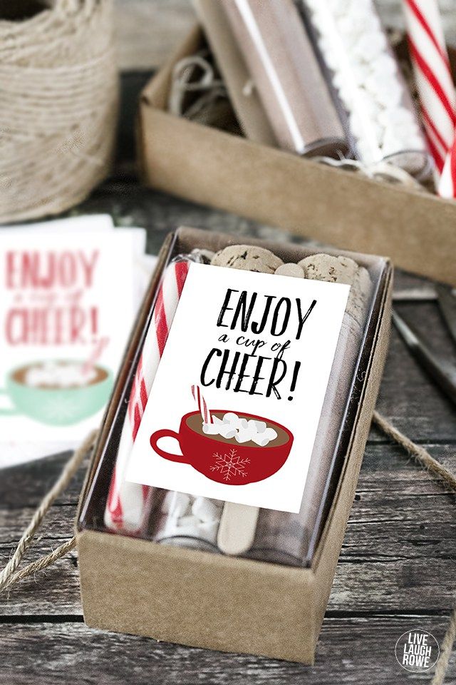 an empty box filled with candy canes next to other holiday decorations and cards on a wooden table