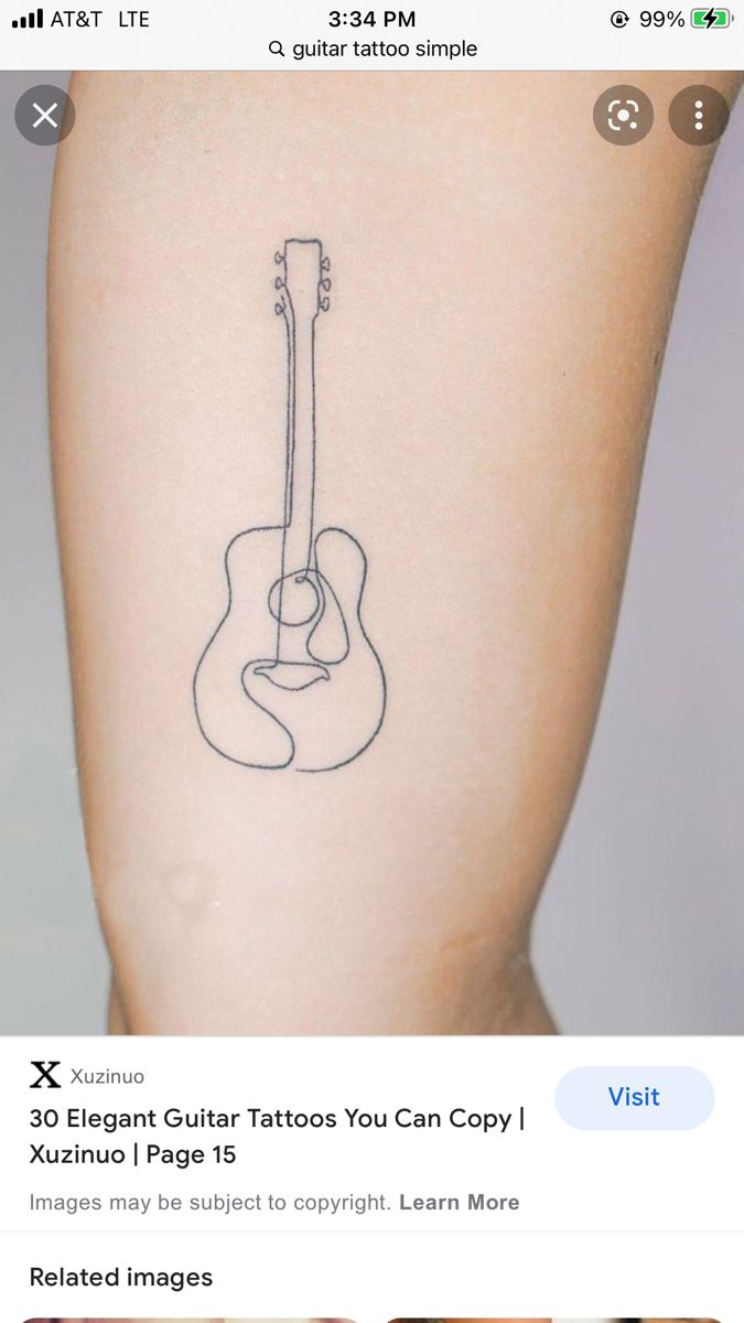 an image of a guitar tattoo on someone's leg