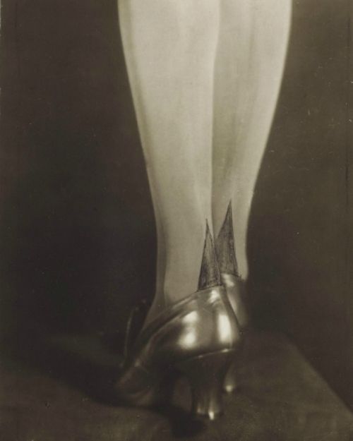 an old black and white photo of a woman's legs