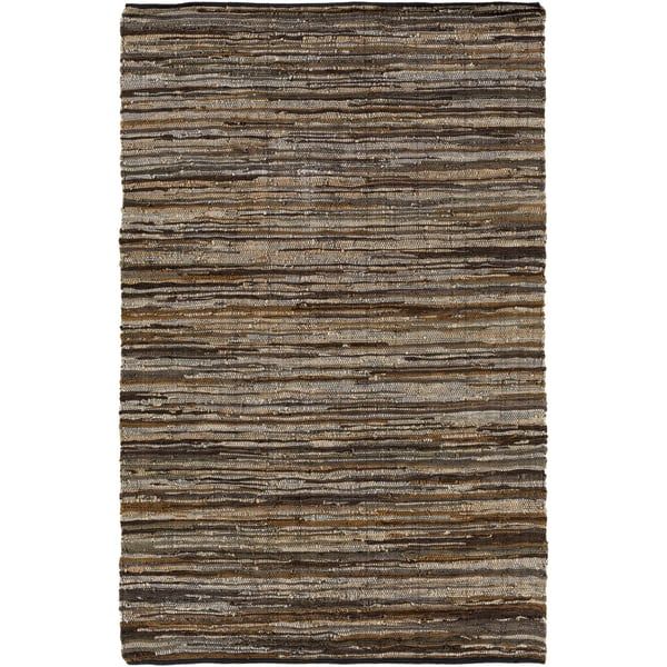 an area rug with brown and black stripes on the bottom, in front of a white background