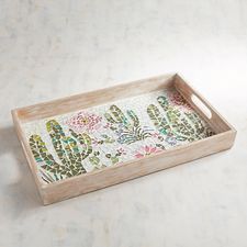 a wooden tray with flowers and leaves on the bottom is sitting on a white surface