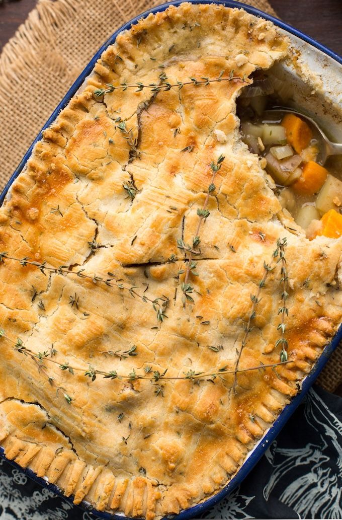 a close up of a pie in a pan on a table with a spoon and napkin