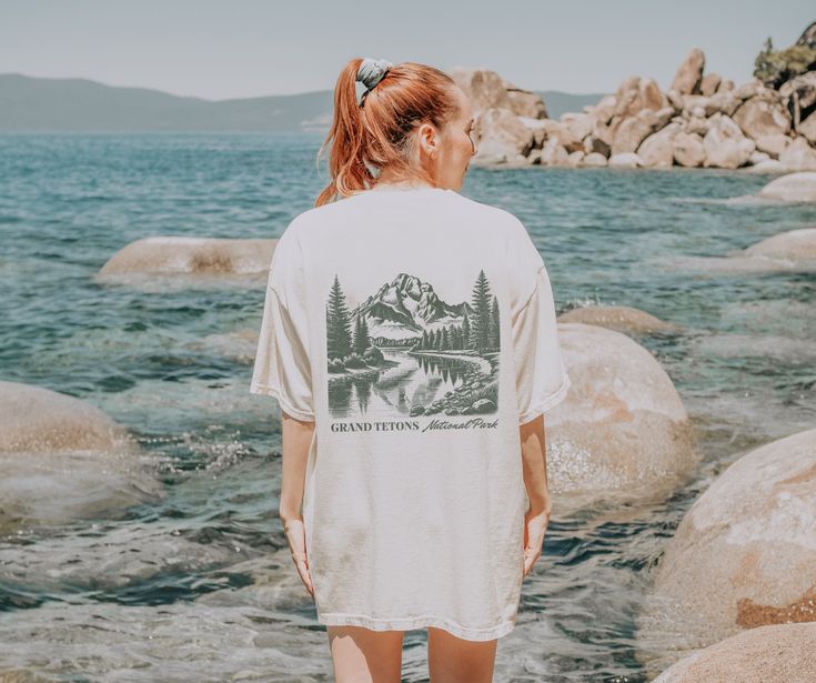 Grand Tetons National Park Comfort Colors Tshirt, Front & Back Graphic Tee, National Park Tshirt, Mountain Adventure Shirt, Granola Girl Tees .: The Comfort Colors 1717 tee is made with medium fabric (6.1 oz/yd² (206.8 g/m consisting of high quality, 100% ring-spun US cotton for long-lasting comfort. .: The relaxed fit keeps the wearer comfy in both casual and semi-formal settings while the crew neckline delivers that classic, neat style which makes it perfect for accessorizing.  .: The pre-shrunk fabric ensures a consistently great fit. Check all available sizes in our Comfort Colors 1717 size chart.  .: All Comfort Colors 1717 shirts feature pre-shrunk cotton for size retention and a signature sewn-in twill label. .: Made using 100% US cotton that is ethically grown and harvested. Gildan National Park Tshirt, Granola Vibes, Granola Girl Aesthetic, Mountain Adventure, Comfort Colors Tshirt, Adventure Shirt, Granola Girl, Neat Style, Lake Life