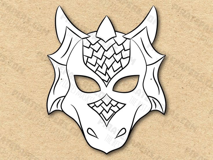 a paper mask with an intricate design on the front and back of it's face