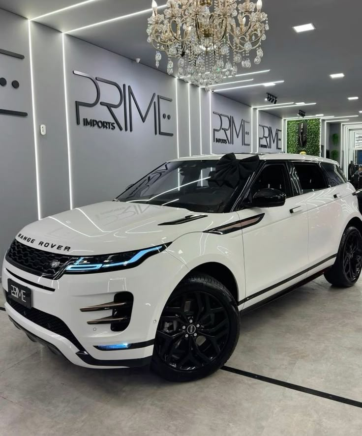 a white range rover parked in a showroom