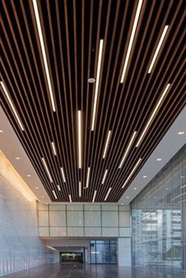 the interior of an empty building with wood slats on the ceiling and wooden flooring