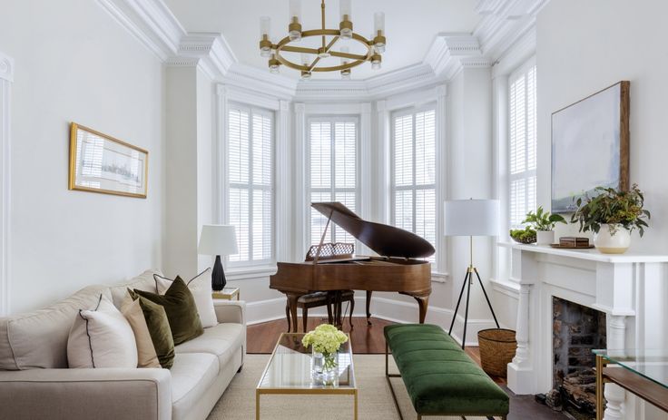 a living room filled with furniture and a grand piano