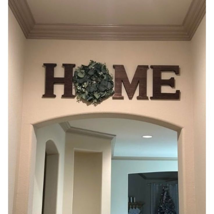 the entrance to a home with a wreath on it